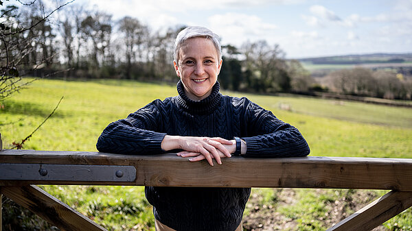 Alex leaning on a gate