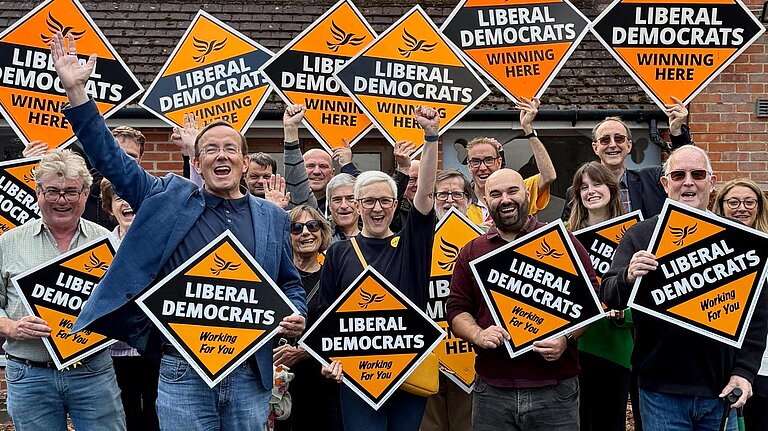 Alex with local Lib Dems holding stakeboards.