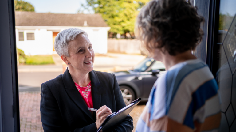 Alex talking to a constituent on their doorstep.