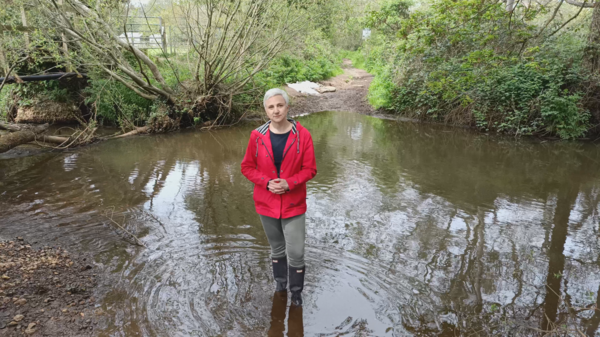 Alex standing in a local river