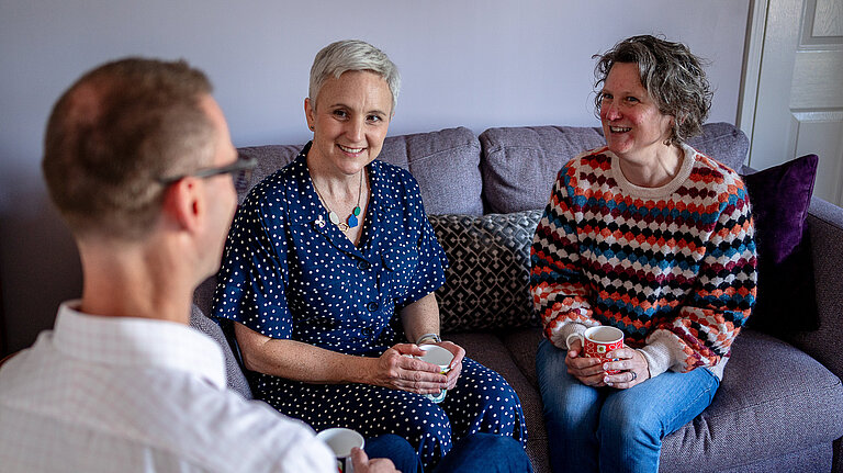 Alex having a cup of tea with constituents.